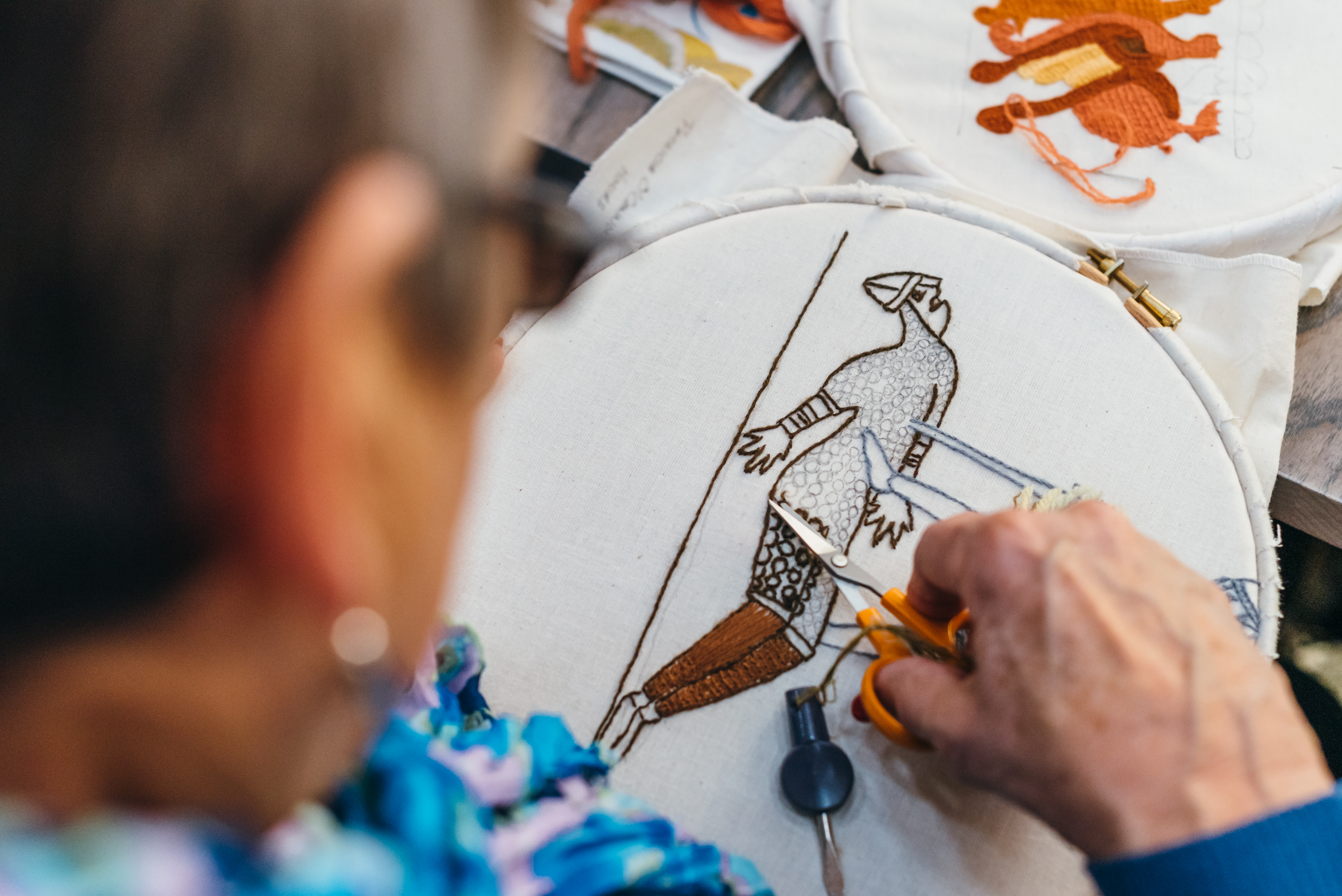 sample of the Norwich Friends Tapestry showing two characters in armour is being stitched in a hoop